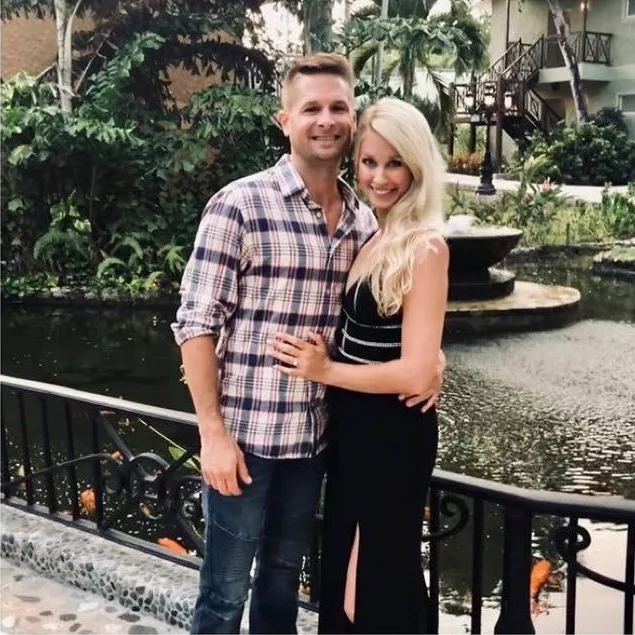 Loren and Ashley by a fountain in a garden